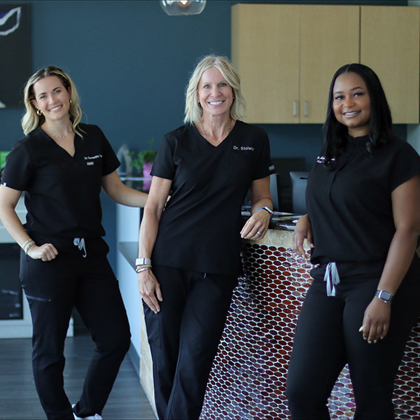 three female doctors smiling
