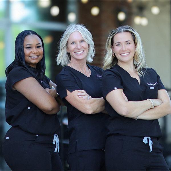 three female doctors smiling
